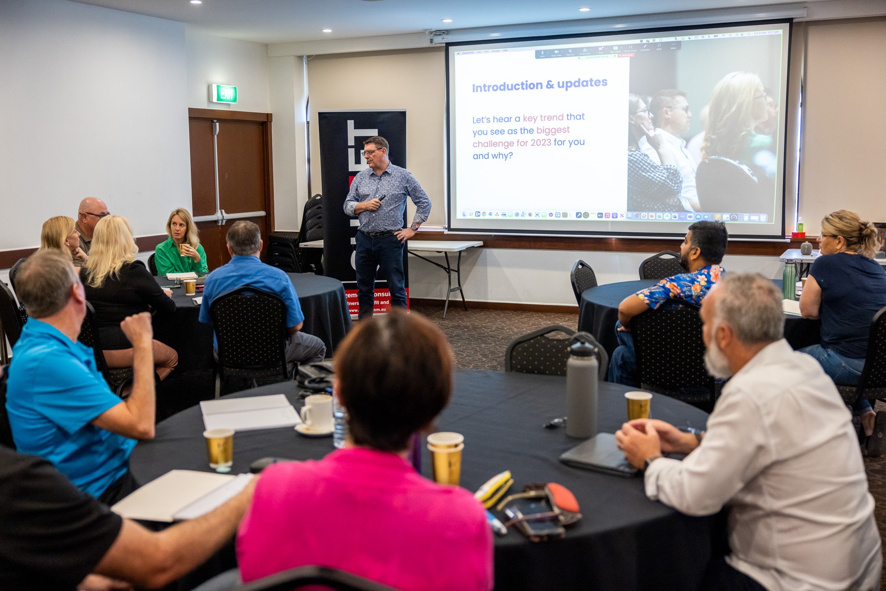 Russell Cummings facilitating a workshop with participants around discussion tables